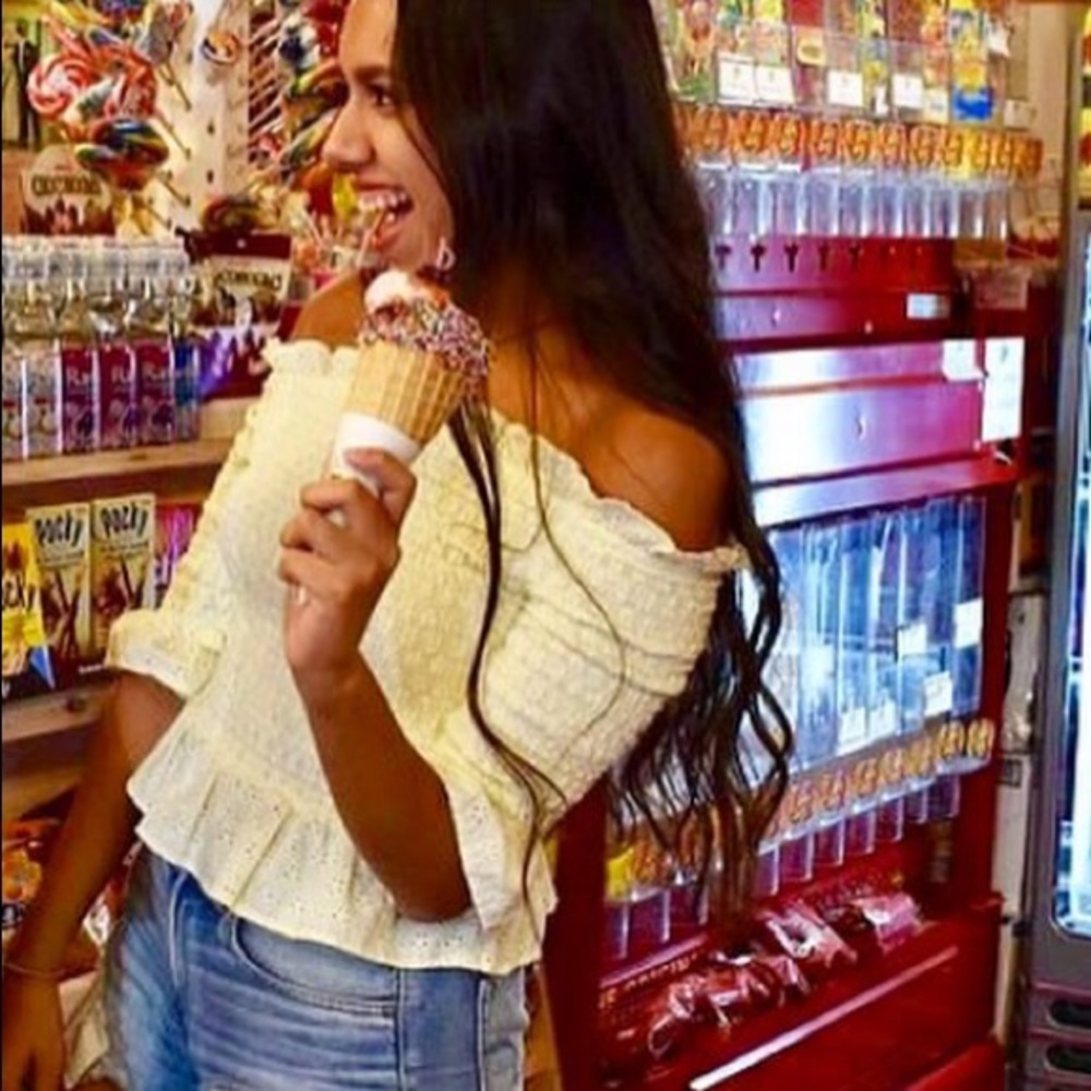 Off shoulder yellow shirt.